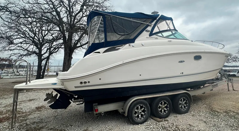 Slide: The Image of 2012 Sea Ray 280 Sundancer boat on a trailer, parked outdoors. - 3