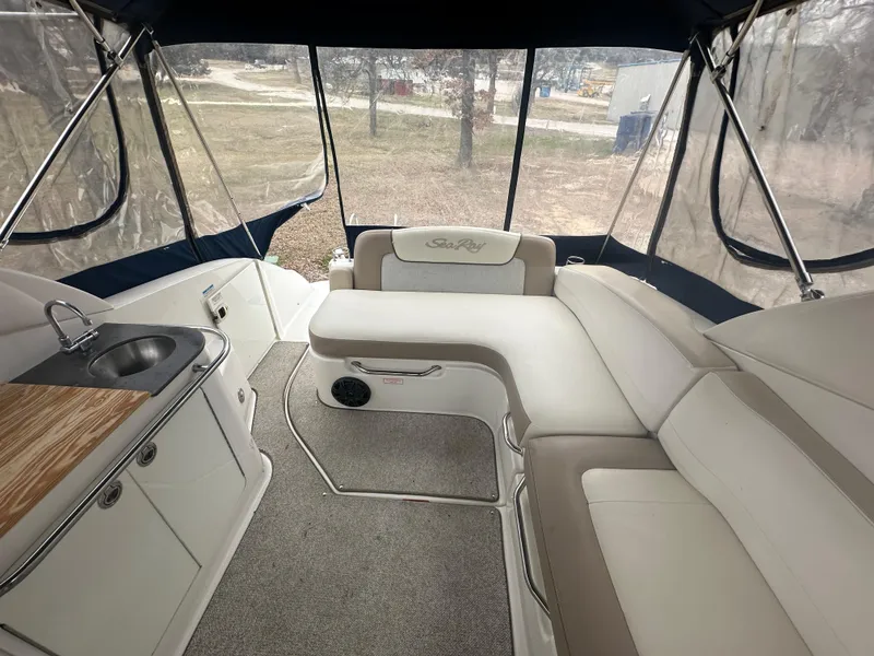 Slide: The Image of 2012 Sea Ray 280 Sundancer interior with seating and kitchenette. - 8