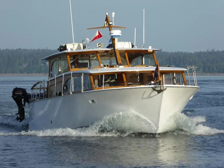The Image of 1959 Monk Express Cruiser navigating through calm waters, showcasing classic design and craftsmanship. - 0