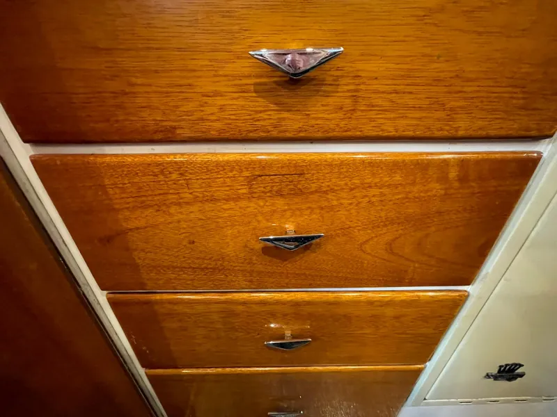 Slide: The Image of Wooden drawers with metal handles inside a 1959 Monk Express Cruiser. - 13