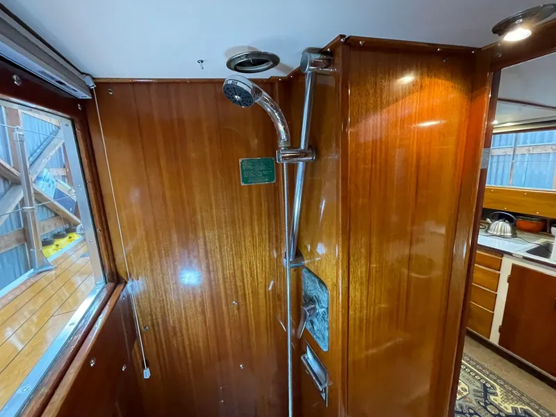 Slide: The Image of 1959 Monk Express Cruiser shower area with wooden paneling and modern fixtures. - 15
