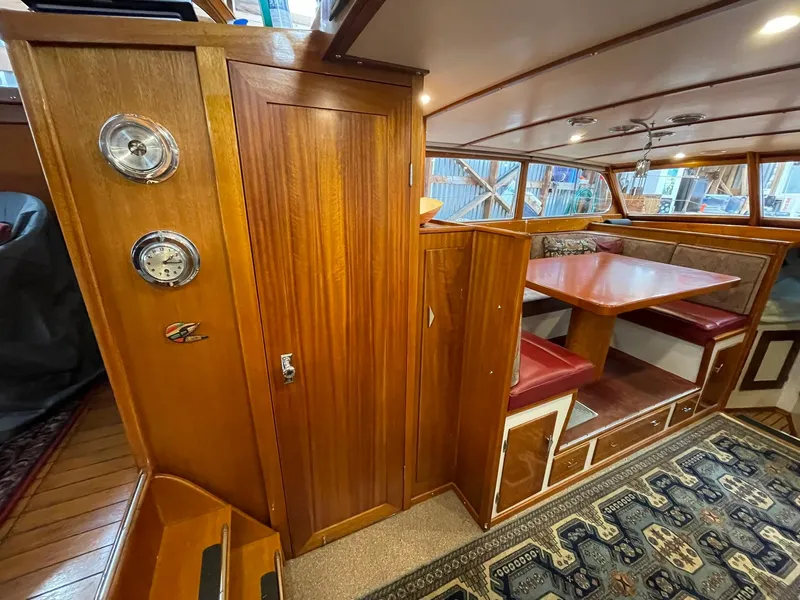 Slide: The Image of 1959 Monk Express Cruiser interior with wood paneling, dining area, and nautical decor. - 20