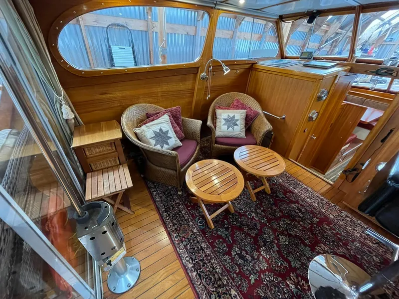 Slide: The Image of 1959 Monk Express Cruiser interior with wicker chairs, wooden tables, and nautical decor. - 22