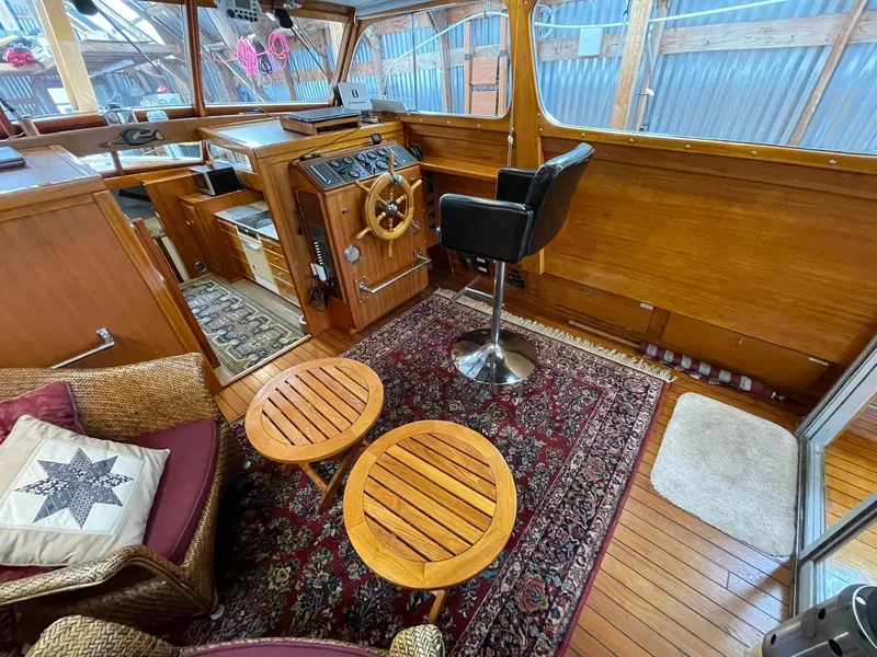 Slide: The Image of 1959 Monk Express Cruiser interior with wooden helm, seating, and nautical decor. - 23