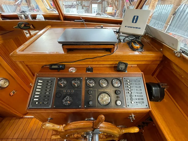 Slide: The Image of 1959 Monk Express Cruiser helm with vintage controls and wooden steering wheel. - 24