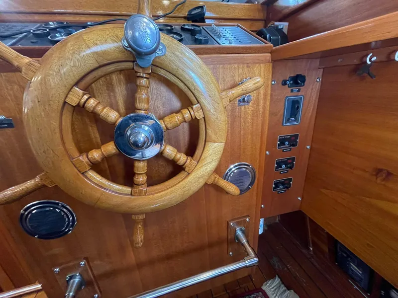 Slide: The Image of 1959 Monk Express Cruiser helm with wooden steering wheel and control panel. - 26