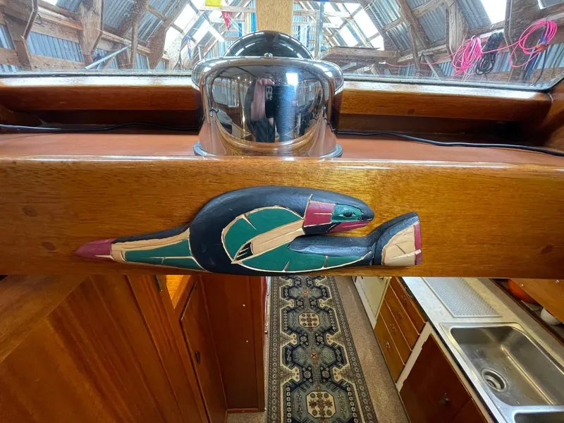 Slide: The Image of 1959 Monk Express Cruiser interior with carved wooden detail and kitchen view. - 29