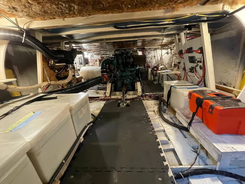 Slide: The Image of Engine room of a 1959 Monk Express Cruiser with visible machinery and equipment. - 33