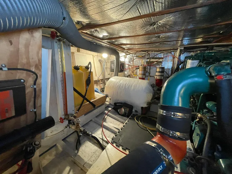 Slide: The Image of Engine room of a 1959 Monk Express Cruiser with visible pipes and equipment. - 35
