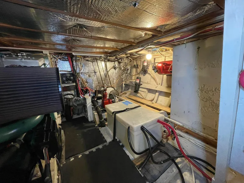 Slide: The Image of Engine room of a 1959 Monk Express Cruiser with visible wiring and equipment. - 36