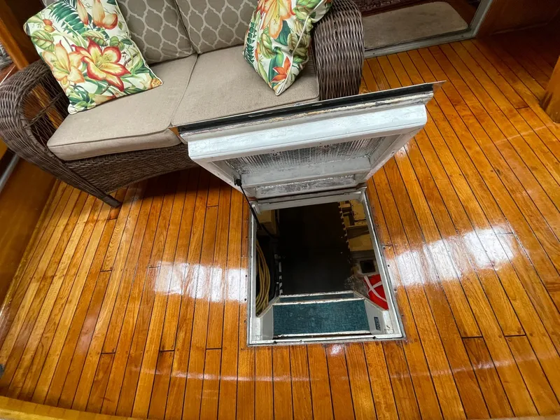 Slide: The Image of 1959 Monk Express Cruiser interior with open hatch on polished wooden floor. - 39