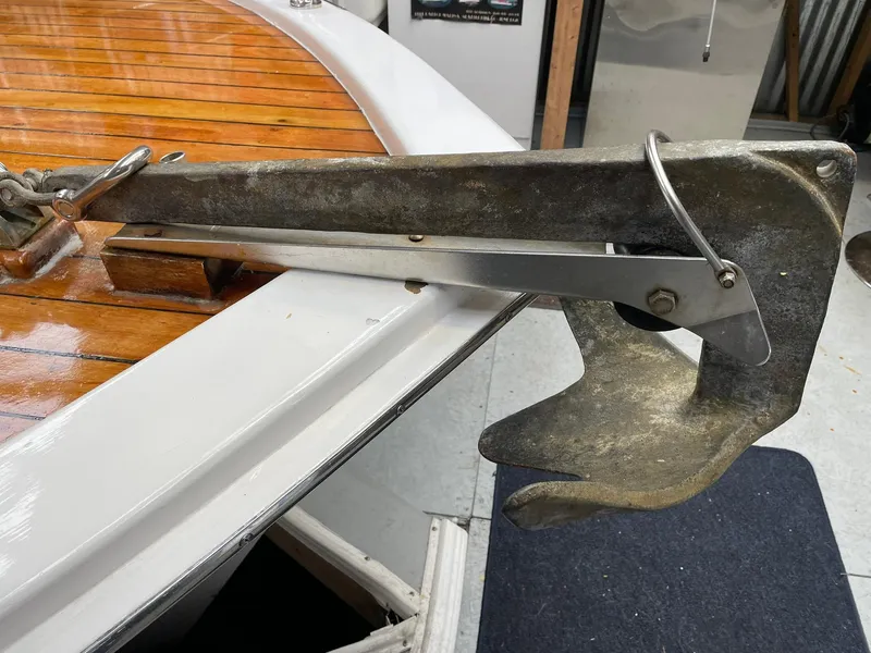 Slide: The Image of 1959 Monk Express Cruiser anchor on polished wooden deck. - 4