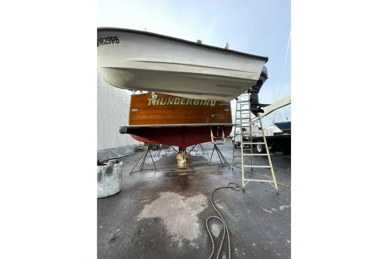 Slide: The Image of 1959 Monk Express Cruiser "Thunderbird" on dry dock, showcasing wooden hull and ladder. - 42
