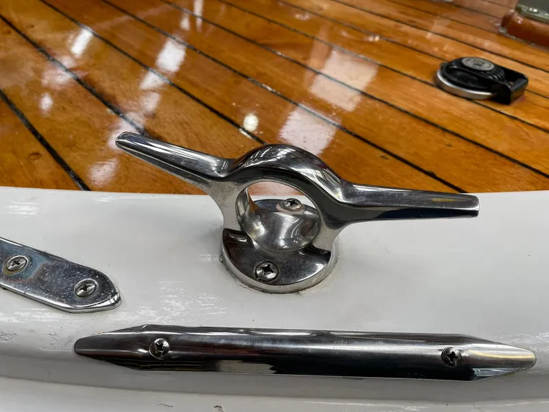 Slide: The Image of 1959 Monk Express Cruiser deck with polished cleat and wooden finish. - 6