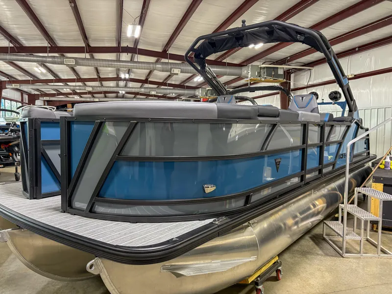 The Image of 2025 Trifecta 23RF SS 3.0 pontoon boat in a warehouse setting. - 1