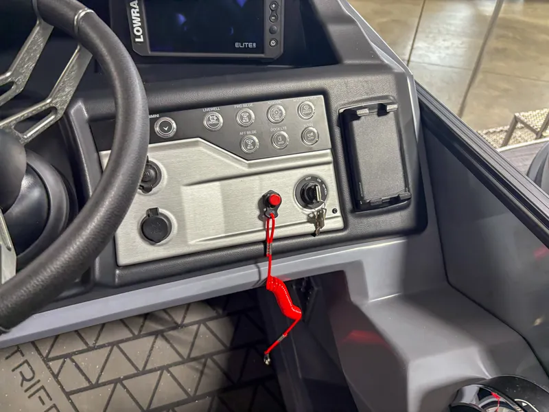 Slide: The Image of Control panel of 2025 Trifecta 23RF SS 3.0 boat with steering wheel and switches. - 10