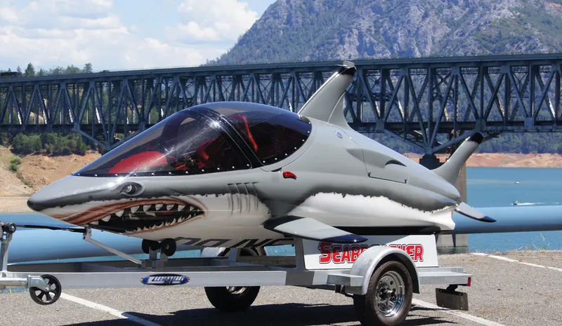Slide: The Image of 2025 Seabreacher X, Y, Z on trailer, shark design, near bridge and lake. - 12