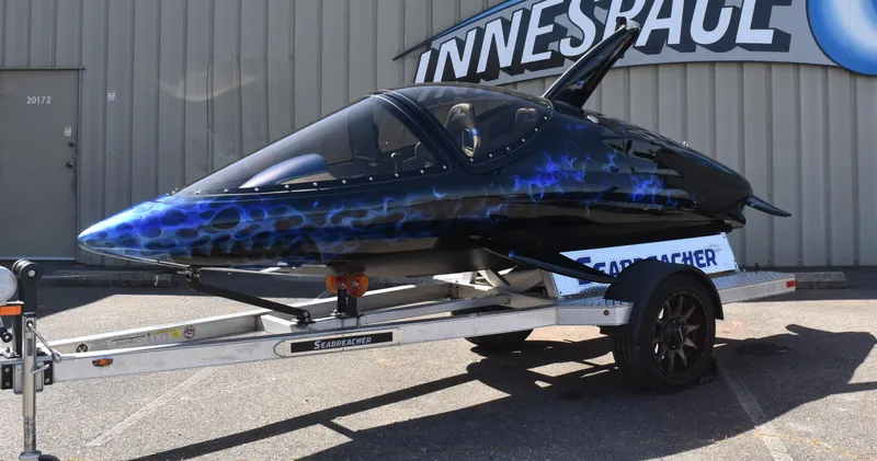 Slide: The Image of 2025 Seabreacher X, Y, Z on trailer, sleek design with blue flame pattern. - 2