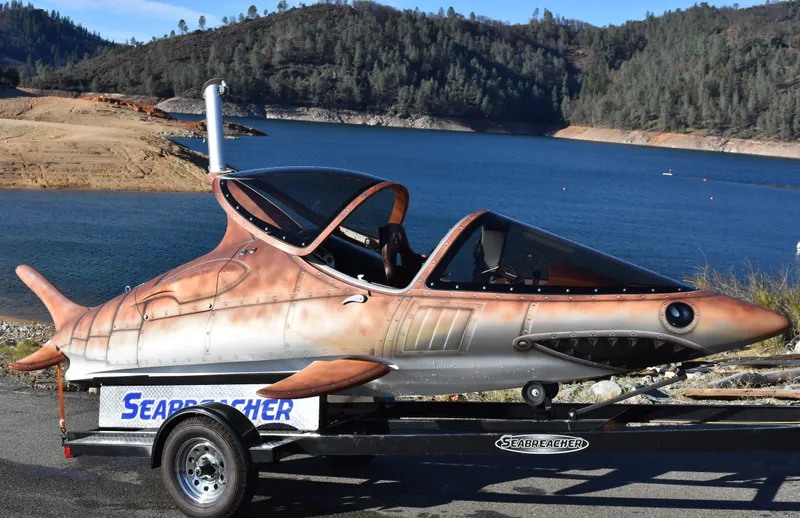 Slide: The Image of 2025 Seabreacher X, Y, Z model on trailer by a scenic lake. - 21