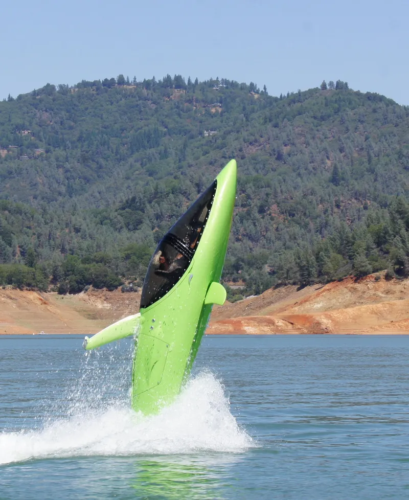 Slide: The Image of 2025 Seabreacher X, Y, Z performing a vertical water maneuver on a lake with forested hills. - 25