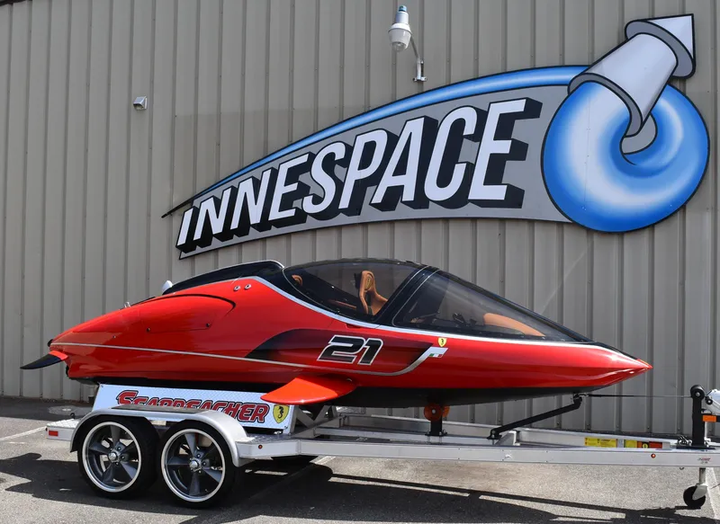 Slide: The Image of 2025 Seabreacher X, Y, Z model in red on trailer outside Innespace facility. - 29