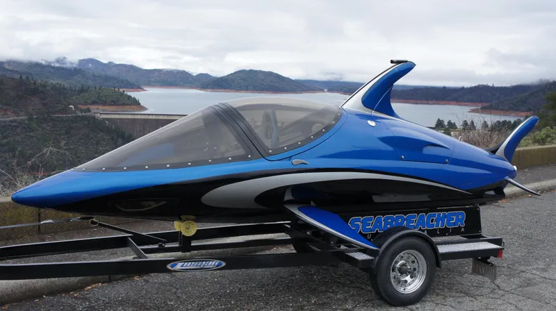 Slide: The Image of 2025 Seabreacher X, Y, Z model on trailer, blue and black design, scenic lake background. - 31
