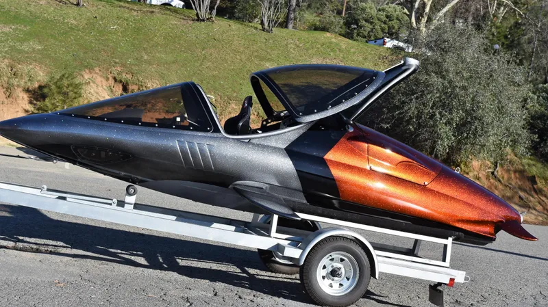 Slide: The Image of 2025 Seabreacher X, Y, Z on trailer, sleek design, black and orange exterior. - 44