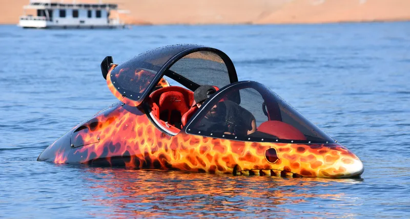 Slide: The Image of 2025 Seabreacher X, Y, Z with fiery design on water, open canopy, red interior. - 9