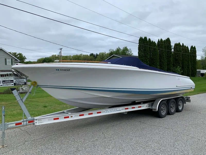 Slide: The Image of 2005 Chris-Craft Corsair 28 boat on a trailer, parked outdoors. - 0
