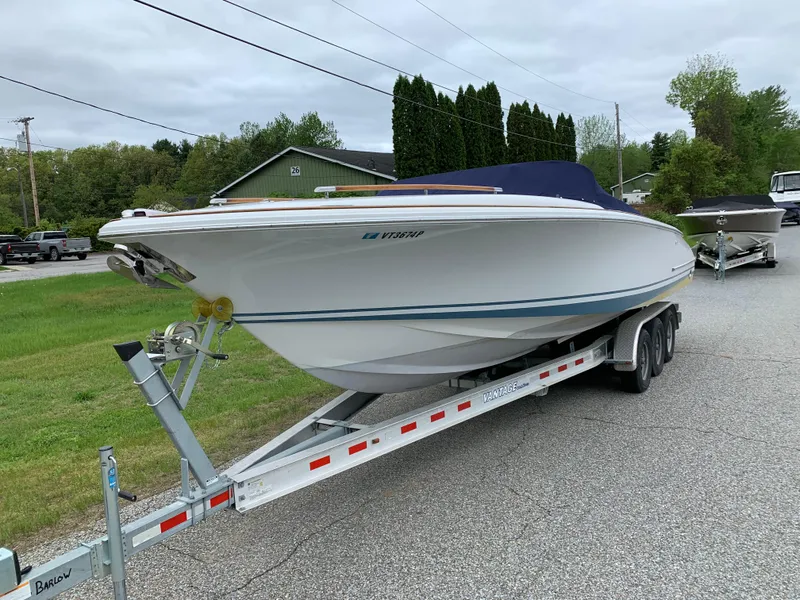 Slide: The Image of 2005 Chris-Craft Corsair 28 boat on trailer, parked on roadside. - 1