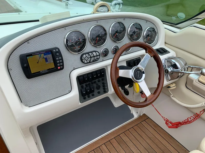 Slide: The Image of Dashboard of a 2005 Chris-Craft Corsair 28 boat with gauges and navigation system. - 15