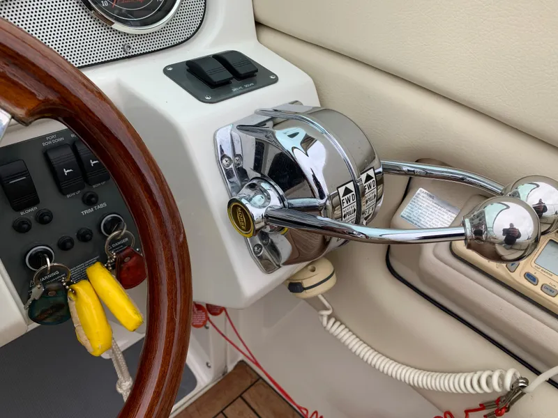 Slide: The Image of Control panel of a 2005 Chris-Craft Corsair 28 boat with steering wheel and throttle. - 16