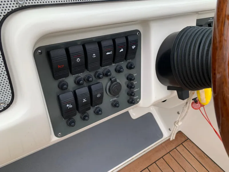 Slide: The Image of Control panel of a 2005 Chris-Craft Corsair 28 boat, featuring various switches and dials. - 17