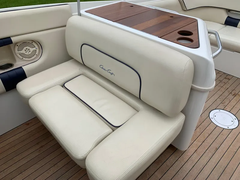 Slide: The Image of 2005 Chris-Craft Corsair 28 boat interior with beige seating and wooden accents. - 19