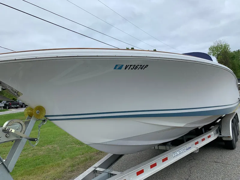 Slide: The Image of 2005 Chris-Craft Corsair 28 boat on trailer, side view, outdoors. - 2