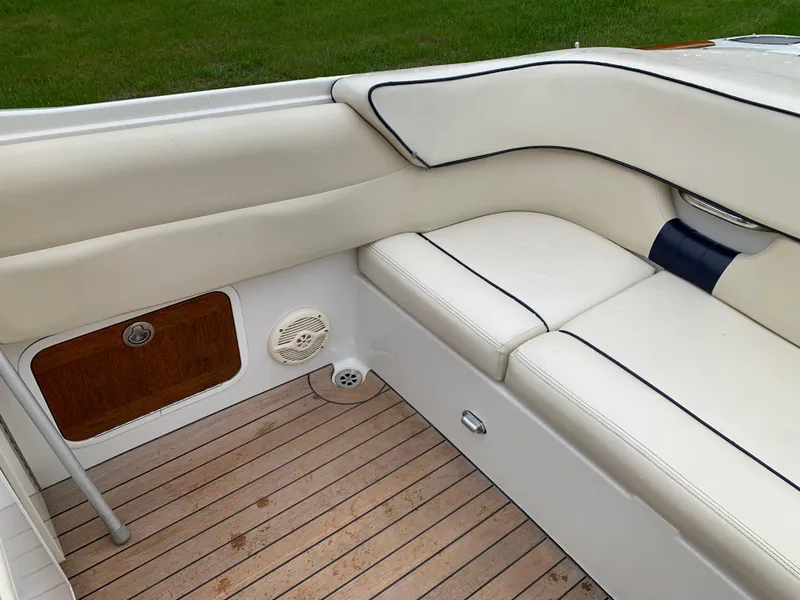 Slide: The Image of 2005 Chris-Craft Corsair 28 interior with white leather seating and wooden flooring. - 23