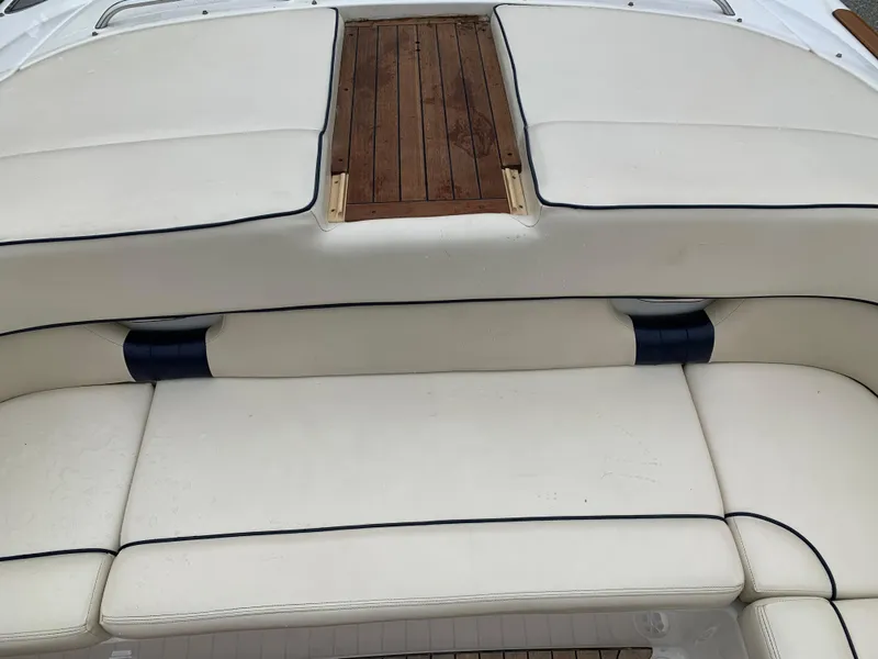 Slide: The Image of 2005 Chris-Craft Corsair 28 boat with white leather seating and wooden deck. - 24