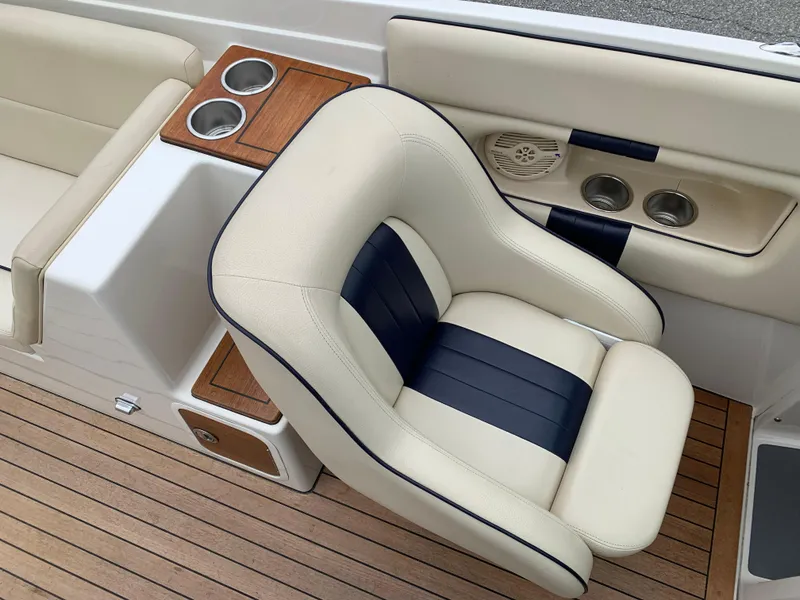Slide: The Image of Luxurious seating on 2005 Chris-Craft Corsair 28 with wood accents and cup holders. - 26
