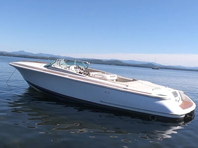 Slide: The Image of 2006 Chris-Craft Corsair 28 boat on calm water, clear sky background. - 31