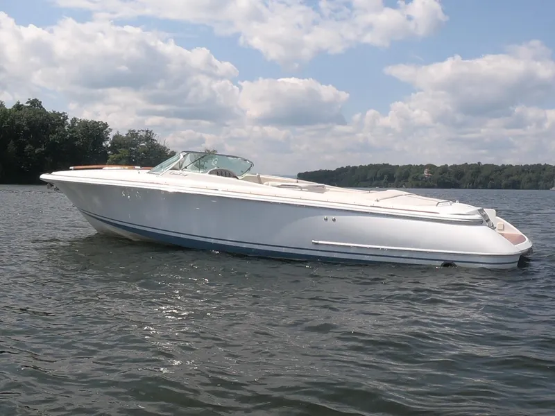 Slide: The Image of 2006 Chris-Craft Corsair 28 boat on a calm lake under a cloudy sky. - 35