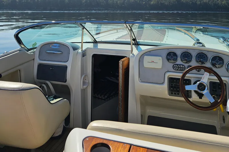Slide: The Image of 2006 Chris-Craft Corsair 28 boat interior with steering wheel and dashboard controls. - 37