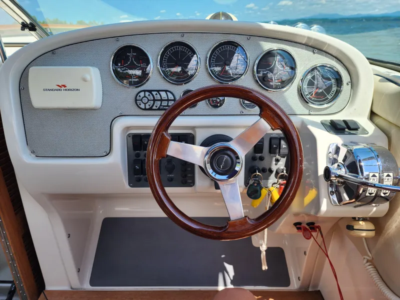 Slide: The Image of 2006 Chris-Craft Corsair 28 dashboard with wooden steering wheel and instrument panel. - 39