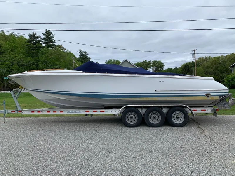 Slide: The Image of 2005 Chris-Craft Corsair 28 boat on a trailer, parked on a road. - 4