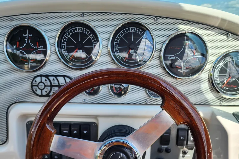 Slide: The Image of Dashboard of 2006 Chris-Craft Corsair 28 with wooden steering wheel and gauges. - 42