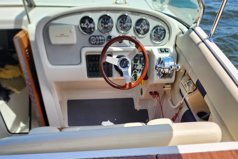 Slide: The Image of 2006 Chris-Craft Corsair 28 cockpit with wooden steering wheel and instrument panel. - 43