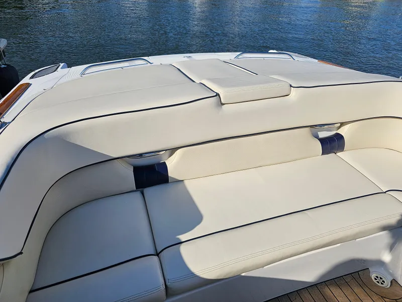 Slide: The Image of 2006 Chris-Craft Corsair 28 boat with white leather seating by the water. - 46