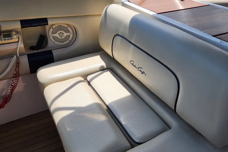 Slide: The Image of 2006 Chris-Craft Corsair 28 interior with cream leather seating and speaker system. - 47