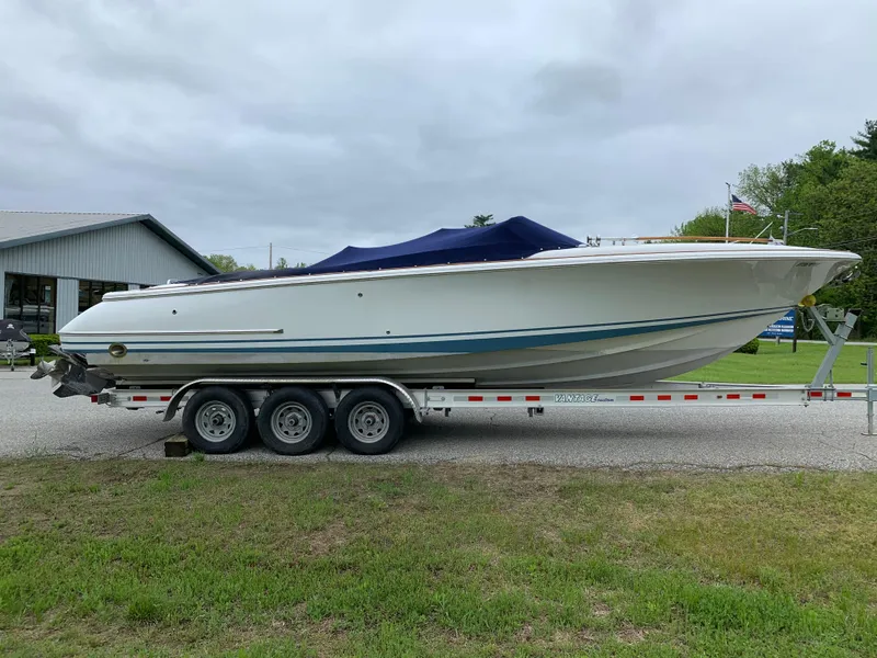 Slide: The Image of 2005 Chris-Craft Corsair 28 boat on a trailer, covered with a blue tarp. - 5