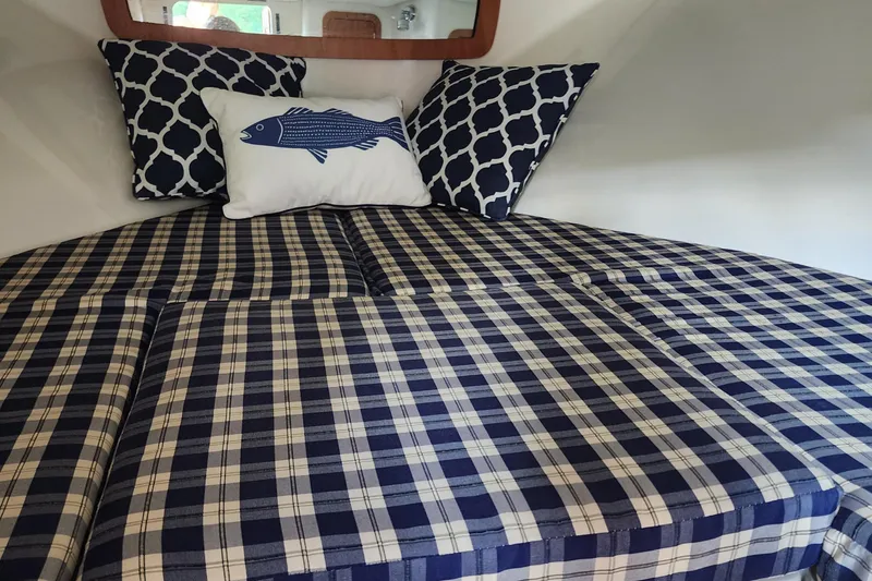 Slide: The Image of Interior cabin of 2006 Chris-Craft Corsair 28 with plaid bedding and decorative pillows. - 50