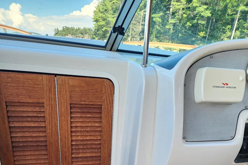 Slide: The Image of 2006 Chris-Craft Corsair 28 interior with wooden paneling and marine speaker. - 54